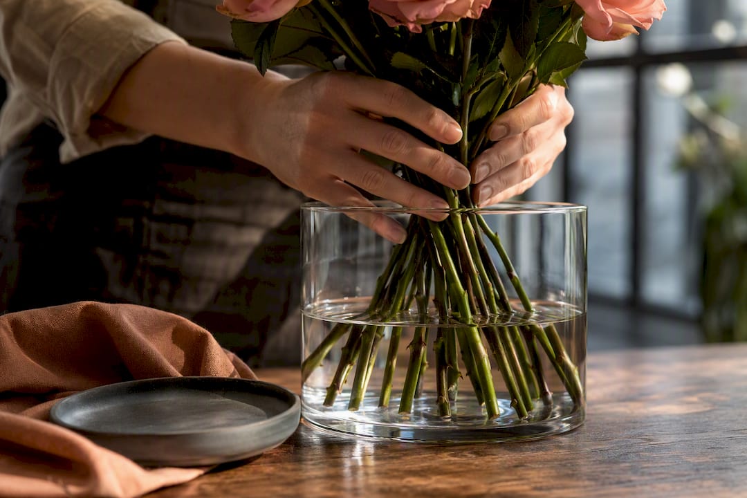 Florist hydrating freshly cut rose stems