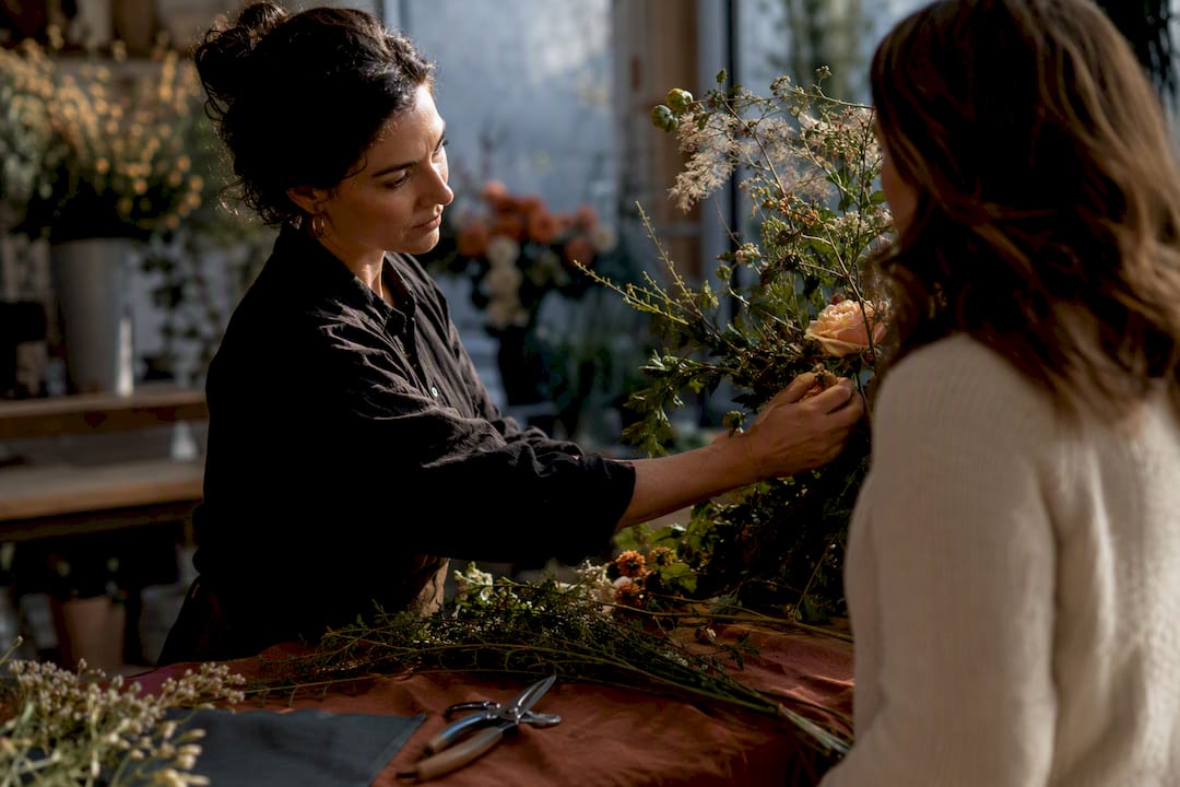 Florist and client reviewing wedding flowers