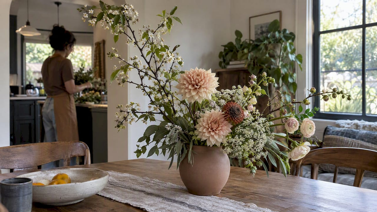 Modern asymmetrical floral arrangement in ceramic vase