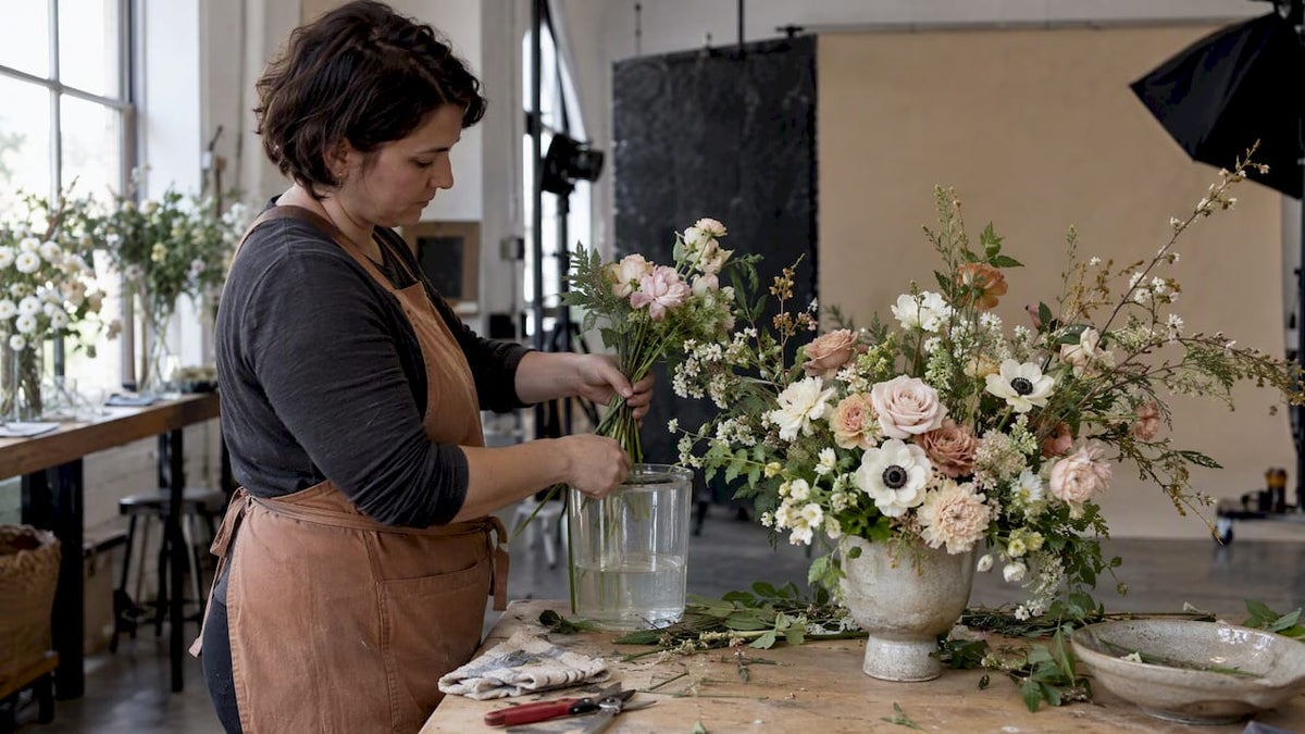 Florist refreshing flowers between photoshoot takes