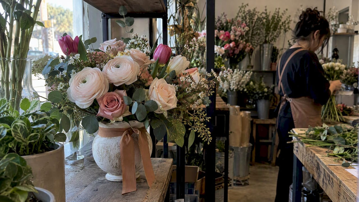 Winter ranunculus and tulip arrangement in shop